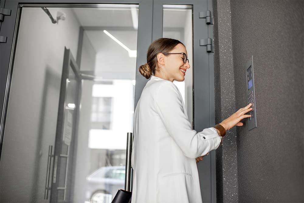 Impiegata digita il codice in un sistema di controllo accessi